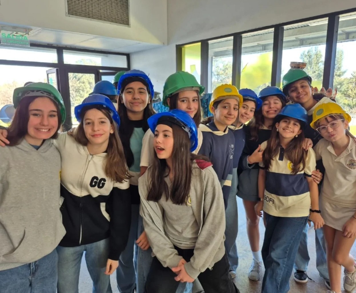 Estudiantes participan en una salida educativa sobre reciclaje y cuidado del ambiente usando cascos de seguridad.
